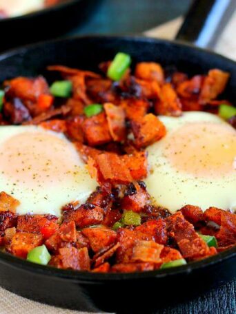 Packed with roasted maple sweet potatoes, fresh eggs, peppers, and bacon, this Roasted Maple Sweet Potato Breakfast Skillet comes together in minutes and makes a hearty breakfast. It's easy to prepare and full of cozy flavors that are perfect on those cool, fall mornings!