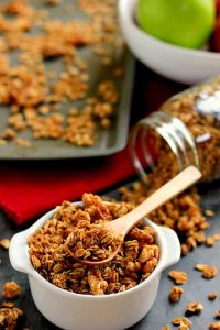 a spoon in a bowl of apple pie granola
