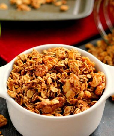 apple pie granola in a dish in front of a baking pan