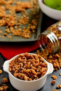 This Apple Pie Granola recipe is jam-packed with hearty oats, walnuts, and cozy fall spices. It makes for a great snack or healthy breakfast and tastes like apple pie, plus it's gluten free! #granola #apples #applegranola #applepie #fallrecipe #fallbreakfast #fallsnack #applesnack #snack #breakfast #glutenfreebreakfast #glutenfreegranola