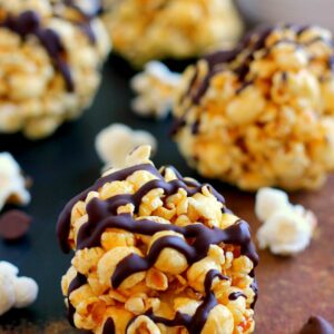 These Caramel Popcorn Balls combine fresh popcorn, caramel sauce, marshmallows, and dark chocolate. This easy snack is perfect to munch on when you need to satisfy those sweet and salty cravings!