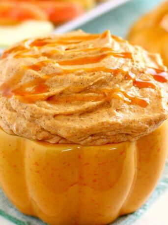 Filled with a cream cheese base and swirled with caramel and pumpkin, this Caramel Pumpkin Cheesecake Dip takes just five minutes to make and captures the flavors of fall. It makes the perfect appetizer or dessert and tastes just like pumpkin cheesecake!