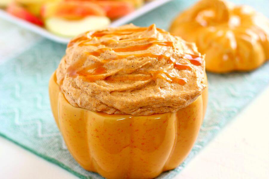 pumpkin pie cheesecake dip in a pumpkin-shaped serving bowl