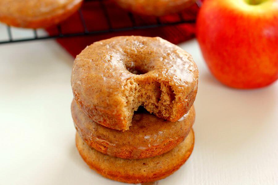 A stack of three baked apple cider donuts.