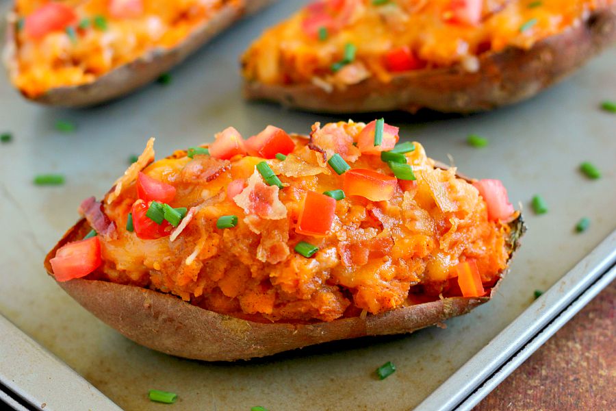 These Loaded Twice Baked Sweet Potatoes make the perfect side dish for any meal. The sweet potatoes are packed with with a brown sugar and cinnamon filling and then topped with cheese, crispy bacon, and sour cream. It's filled with flavor and the perfect fall dish for when you want something warm and comforting!