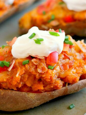 These Loaded Twice Baked Sweet Potatoes make the perfect side dish for any meal. The sweet potatoes are packed with with a brown sugar and cinnamon filling and then topped with cheese, crispy bacon, and sour cream. It's filled with flavor and the perfect fall dish for when you want something warm and comforting!