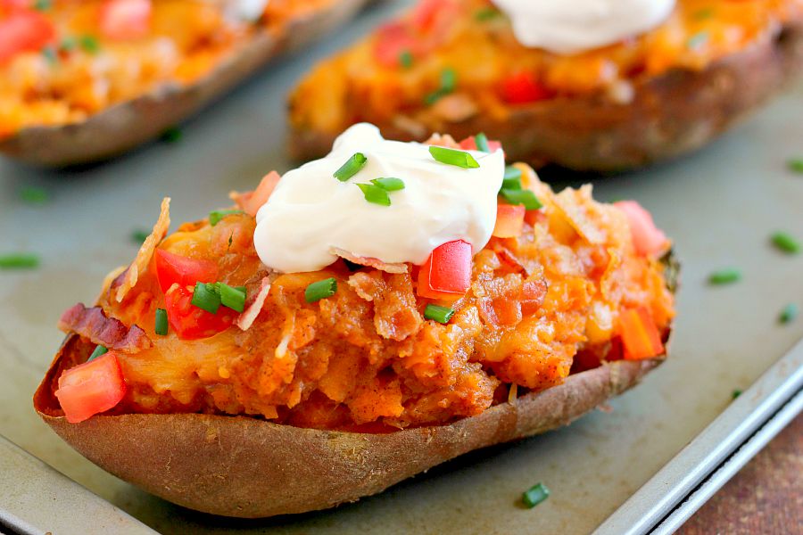 These Loaded Twice Baked Sweet Potatoes make the perfect side dish for any meal. The sweet potatoes are packed with with a brown sugar and cinnamon filling and then topped with cheese, crispy bacon, and sour cream. It's filled with flavor and the perfect fall dish for when you want something warm and comforting!