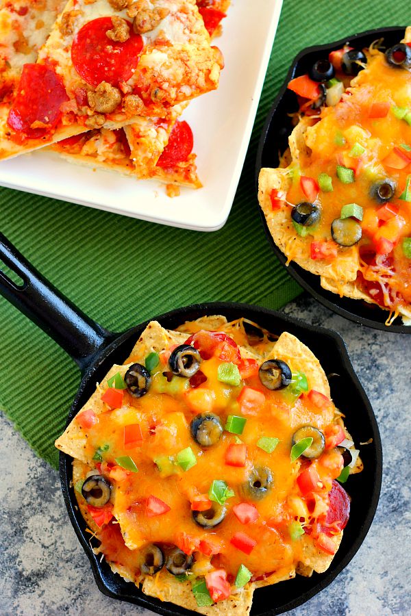 These Pizza Skillet Nachos are packed with two kinds of cheese, hearty pepperoni, black olives, tomatoes, and green peppers. Filled with classic pizza toppings, this is the perfect snack to munch on while relaxing on game day!
