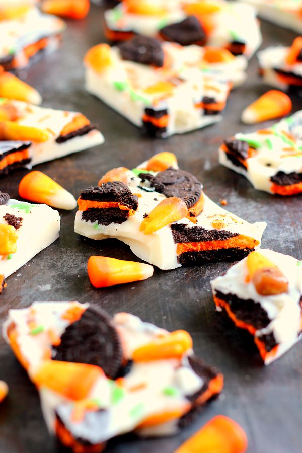 This White Chocolate Boo Bark is filled with creamy white chocolate, Oreo cookies, and chewy candy corn. It's so easy to make and is the perfect snack to munch on during Halloween! #boobark #halloween #sweet #treat #dessert #halloweendessert #whitechocolaterecipe #chocolatebark