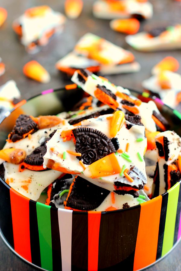 This White Chocolate Boo Bark is filled with creamy white chocolate, Oreo cookies, and chewy candy corn. It's so easy to make and is the perfect snack to munch on during Halloween! #boobark #halloween #sweet #treat #dessert #halloweendessert #whitechocolaterecipe #chocolatebark