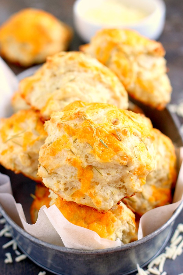 These Cheddar Rosemary Biscuits are soft, flaky, and bursting with flavor. The fresh cheddar cheese and rosemary gives these biscuits the perfect amount of zest. And best of all, it's ready in less than 20 minutes! #biscuits #cheddarbiscuits #rosemary #rosemarybiscuits #biscuitrecipe #sidedish #easysidedish