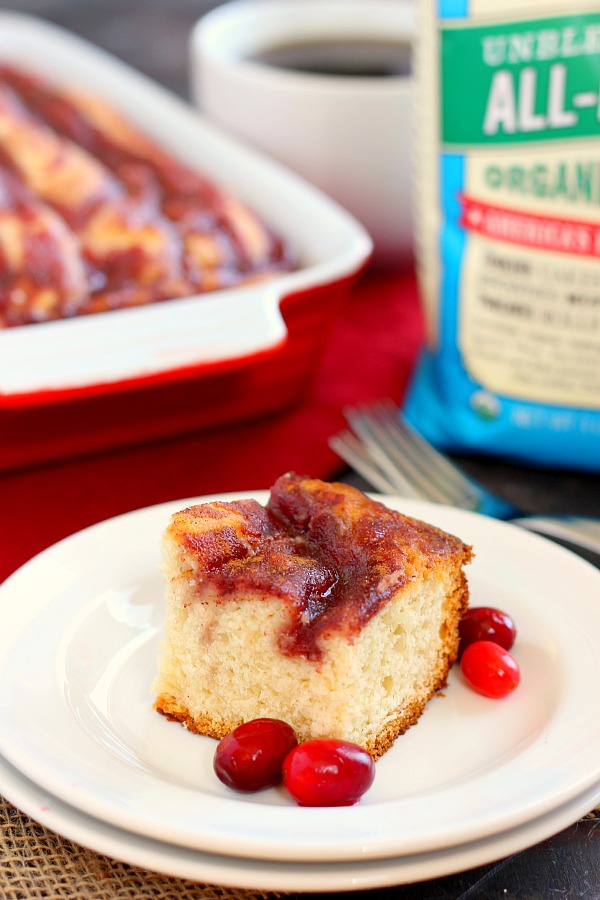 A slice of cranberry sauce coffee cake on a white plate. 