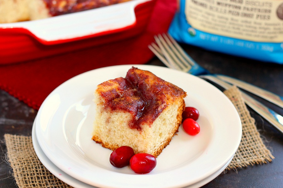 A slice of cranberry sauce coffee cake on a white plate. 