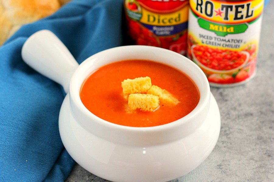A white soup bowl of homemade creamy tomato soup. 