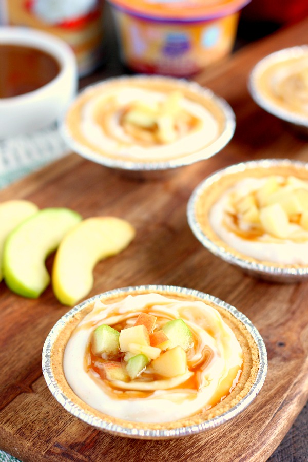 With just a few simple ingredients, these Mini Caramel Apple Yogurt Pies come together in no time and serve as a healthier treat. Filled with sweet yogurt, fresh apple chunks, and a cinnamon swirl, these pies make the perfect fall dessert! #yogurt #yogurtrecipes #caramelapplerecipes #healthybreakfast #healthyrecipes #fallrecipes