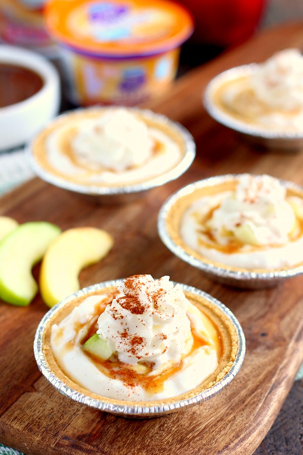 With just a few simple ingredients, these Mini Caramel Apple Yogurt Pies come together in no time and serve as a healthier treat. Filled with sweet yogurt, fresh apple chunks, and a cinnamon swirl, these pies make the perfect fall dessert! #yogurt #yogurtrecipes #caramelapplerecipes #healthybreakfast #healthyrecipes #fallrecipes