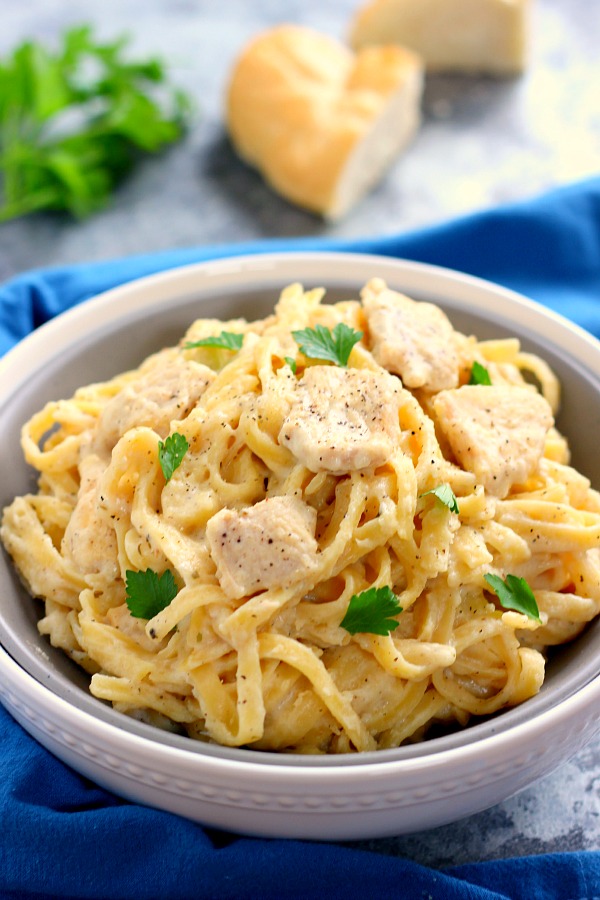 chicken fettuccine alfredo in white bowl 