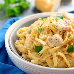 This One Pan Chicken Fettuccine Alfredo is filled with tender chicken and fresh pasta that's tossed in a lightened, creamy sauce. It's made in one pan and ready in just 30 minutes!