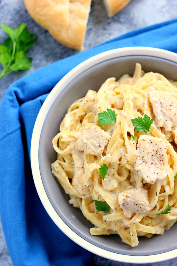 overhead view of chicken fettuccine alfredo garnished with fresh parsley