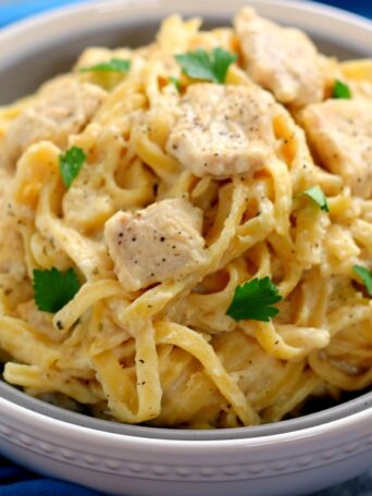 This One Pan Chicken Fettuccine Alfredo is filled with tender chicken and fresh pasta that's tossed in a lightened, creamy sauce. It's made in one pan and ready in just 30 minutes!