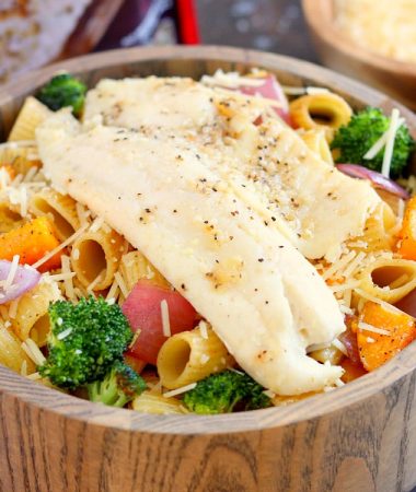 This Tilapia with Roasted Vegetable Pasta features tender rigatoni that is lightly seasoned and filled with fresh, roasted vegetables and topped with flaky tilapia. It's a gourmet meal that can be prepped and ready to eat in just 25 minutes!