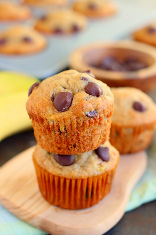 Two banana chocolate chip muffins stacked on each other. 