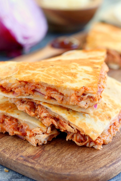 a stack of three sections of a bbq chicken quesadilla