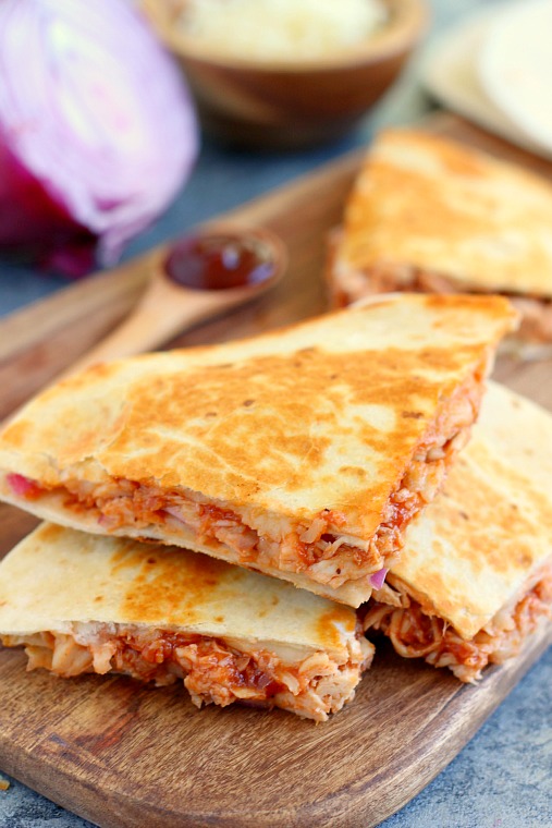 slices of bbq quesadilla on a wood board 