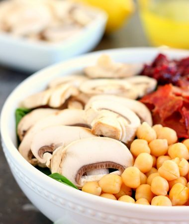 This Cranberry Mushroom Spinach Salad with Lemon Basil Vinaigrette combines baby spinach leaves, dried cranberries, fresh mushrooms, chickpeas, and crumbled bacon, all tossed with a lemon basil dressing. This dish is easy to throw together and serves as the perfect lunch or dinner!