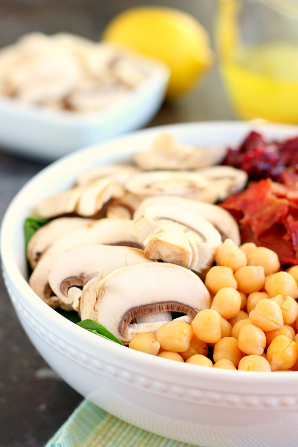 This Cranberry Mushroom Spinach Salad with Lemon Basil Vinaigrette combines baby spinach leaves, dried cranberries, fresh mushrooms, chickpeas, and crumbled bacon, all tossed with a lemon basil dressing. This dish is easy to throw together and serves as the perfect lunch or dinner!