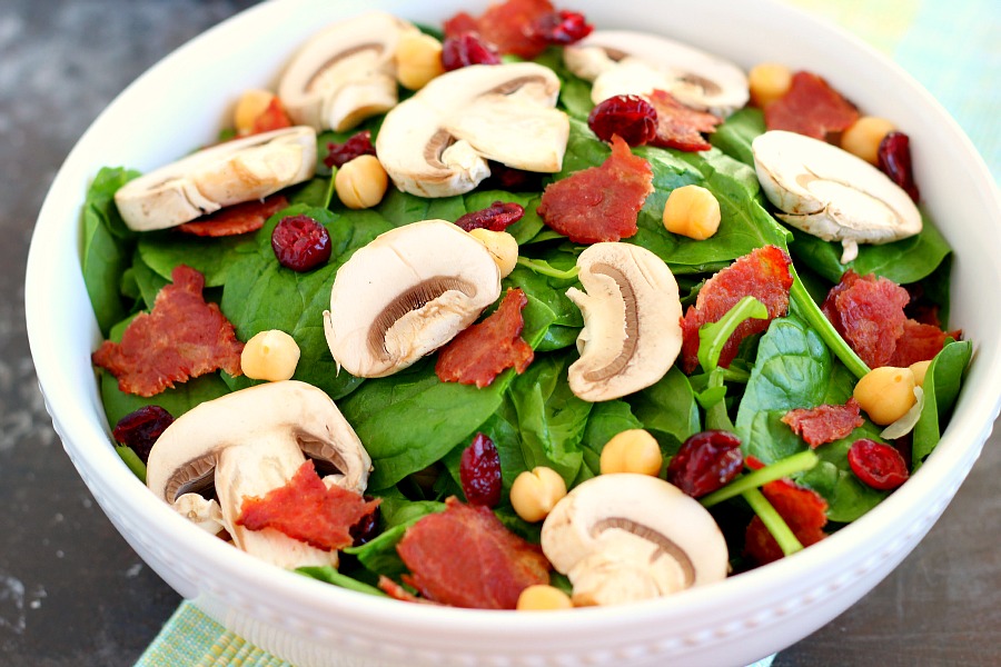 This Cranberry Mushroom Spinach Salad with Lemon Basil Vinaigrette combines baby spinach leaves, dried cranberries, fresh mushrooms, chickpeas, and crumbled bacon, all tossed with a lemon basil dressing. This dish is easy to throw together and serves as the perfect lunch or dinner!