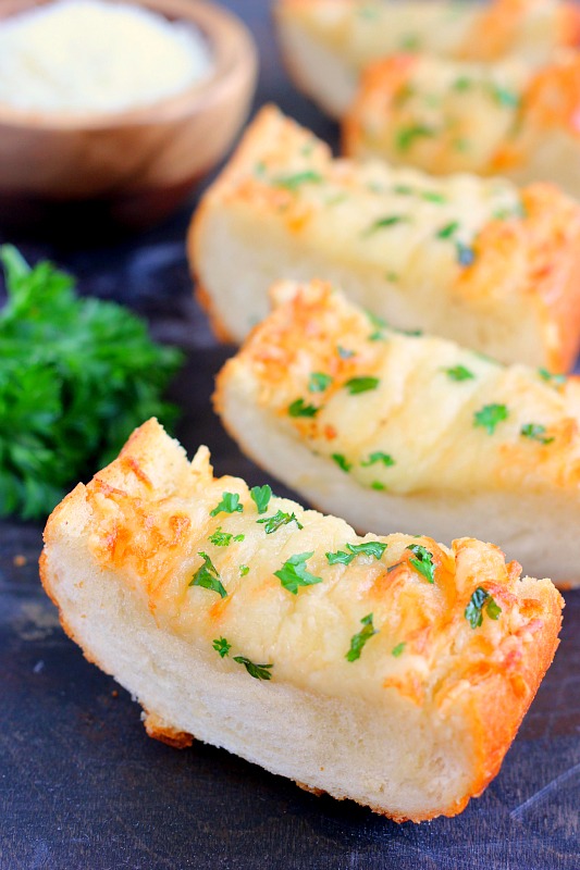 slices of cheesy garlic bread garnished with parsley