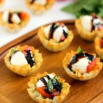 These Caprese Cups are a delicious bite-sized appetizer that will be the hit of your next party! Filled with cherry tomatoes, mozzarella cheese, fresh basil and a drizzle of balsamic glaze, these bites are easy to make and even better to eat!