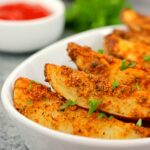 baked garlic parmesan potato wedges in a white bowl