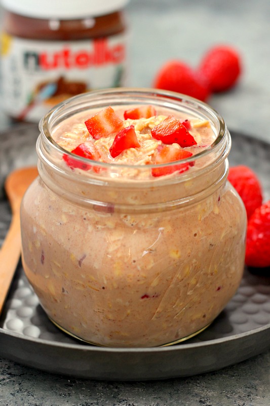Glass jar of strawberry Nutella overnight oats. 