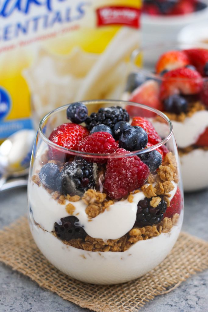 Two glasses full of fruit and yogurt granola.