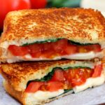 This Caprese Grilled Cheese is filled with fresh basil, creamy mozzarella cheese, and juicy tomatoes. It's a unique twist on a classic sandwich that is packed with flavor and easy to prepare!