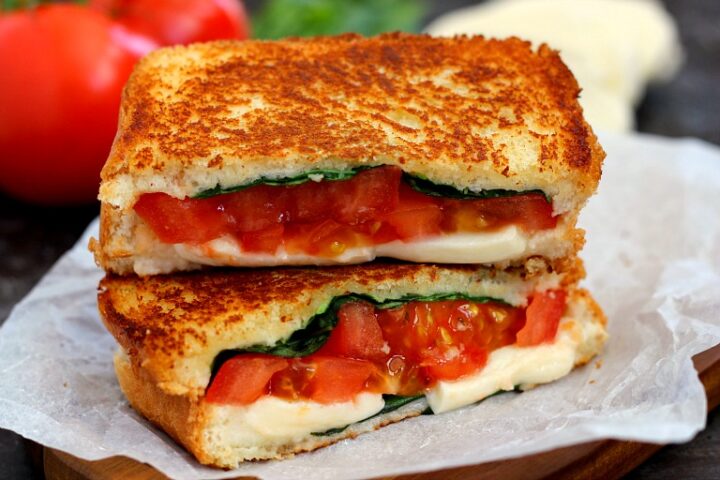 A caprese grilled cheese that's been sliced in half and stacked on itself.