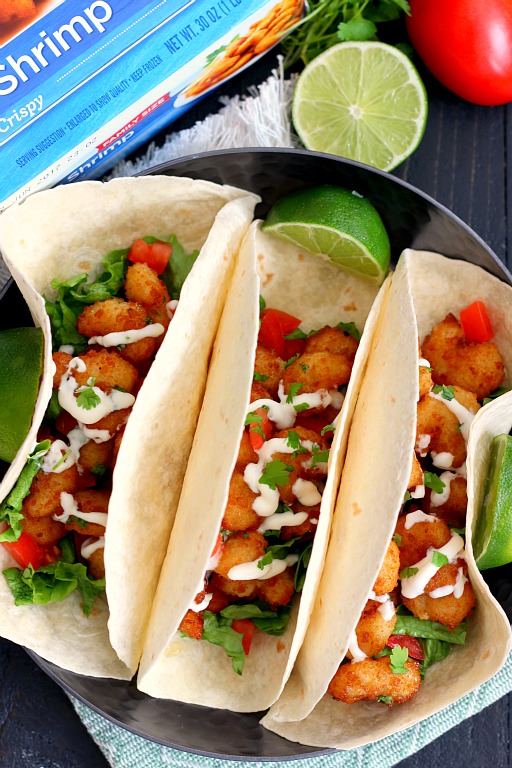 These Cilantro Lime Popcorn Shrimp Tacos are filled with crispy popcorn shrimp, a zesty cilantro lime sauce, and topped with a cilantro cream drizzle. Easy to make and ready in just 20 minutes, this flavorful dish will be the hit of your dinner table!
