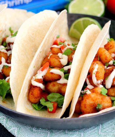These Cilantro Lime Popcorn Shrimp Tacos are filled with crispy popcorn shrimp, a zesty cilantro lime sauce, and topped with a cilantro cream drizzle. Easy to make and ready in just 20 minutes, this flavorful dish will be the hit of your dinner table!