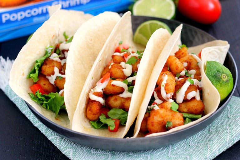 These Cilantro Lime Popcorn Shrimp Tacos are filled with crispy popcorn shrimp, a zesty cilantro lime sauce, and topped with a cilantro cream drizzle. Easy to make and ready in just 20 minutes, this flavorful dish will be the hit of your dinner table!