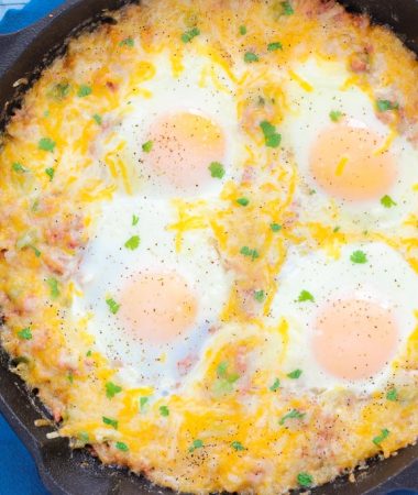 This Corned Beef Hash and Eggs is filled with tender potatoes, chunks of corned beef, green peppers, and spices. It's topped with eggs and a sprinkling of cheese, and then baked to perfection. If you're looking for a zesty breakfast or brunch option, then you'll love this flavorful skillet!