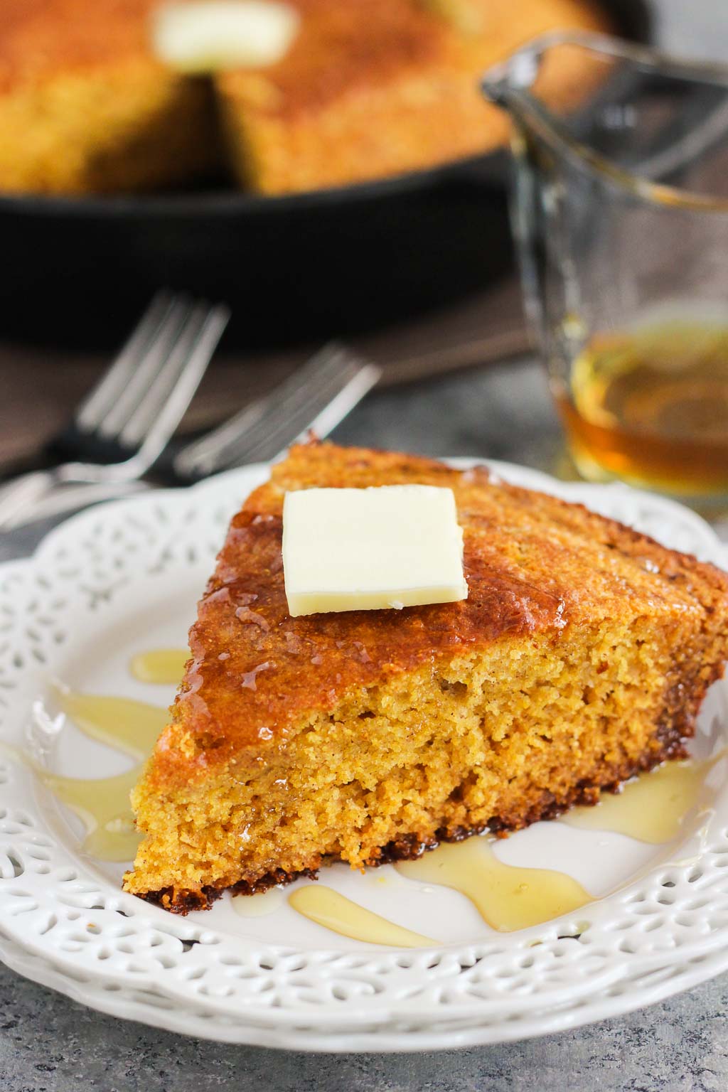 This Skillet Honey Cornbread is soft, moist, and bursting with flavor. The batter is sweetened with honey and cinnamon, and then baked in a skillet until golden brown. It results in a crispy topping and a tender middle, perfect for serving alongside your favorite meal or just to snack on!