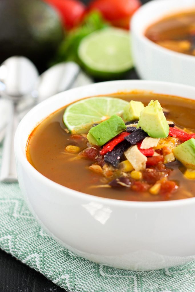 This Slow Cooker Chicken Tortilla Soup is filled with tender chicken, diced tomatoes, corn, black beans, and a combination of spices. With hardly any prep work involved, this flavorful meal will quickly become a household favorite!