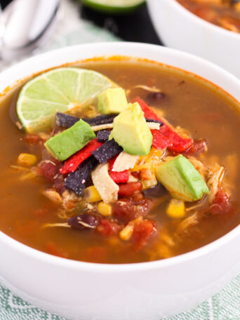 This Slow Cooker Chicken Tortilla Soup is filled with tender chicken, diced tomatoes, corn, black beans, and a combination of spices. With hardly any prep work involved, this flavorful meal will quickly become a household favorite!