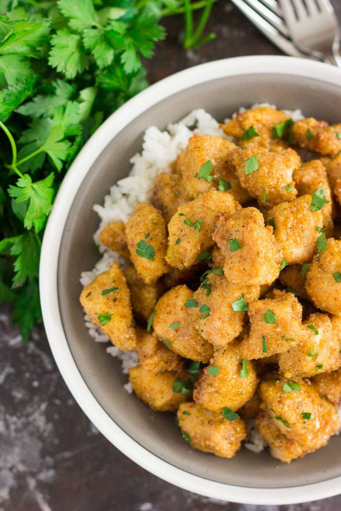 top down shot of honey garlic chicken in a bowl over rice