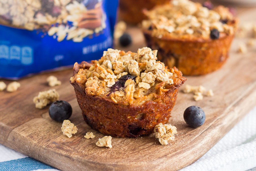 These Blueberry Granola Oatmeal Muffins are packed with hearty oats, fresh blueberries, and topped with sweet granola. Crunchy on the outside and soft on the inside, this simple breakfast can be prepped the night before and made in the morning. These muffins make the most deliciously easy on-the-go breakfast or snack!