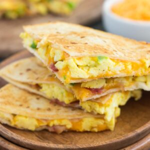 These Easy Breakfast Quesadillas are filled with fluffy, scrambled eggs, green peppers, bacon and cheddar cheeses, all enveloped between two crispy tortilla shells. It's an easy meal that's perfect for busy mornings!