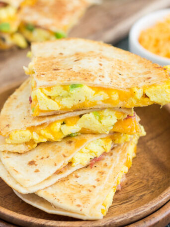 These Easy Breakfast Quesadillas are filled with fluffy, scrambled eggs, green peppers, bacon and cheddar cheeses, all enveloped between two crispy tortilla shells. It's an easy meal that's perfect for busy mornings!