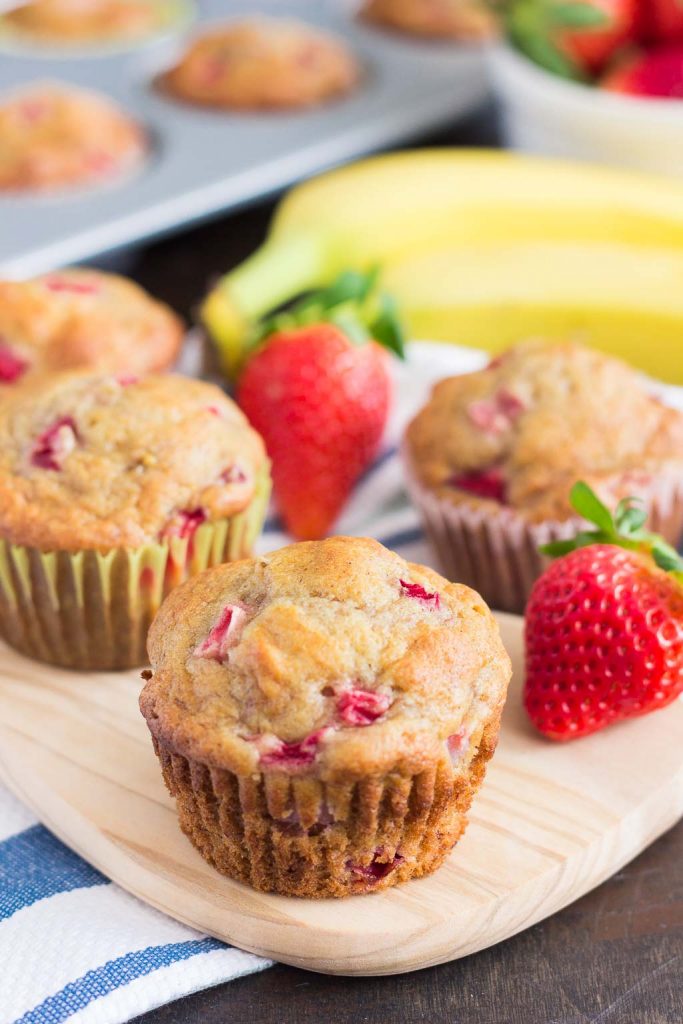 strawberry banana muffins on a cutting board